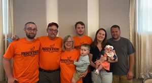Myelodysplastic syndrome (MDS) survivor Craig Super posing with his family wearing orange shirts